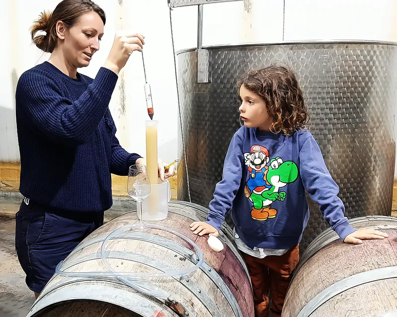 Drawing a barrel sample while a child watches